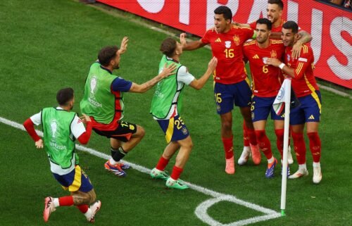 Spain's Mikel Merino celebrates with teammates after scoring the quarterfinal winner against Germany.