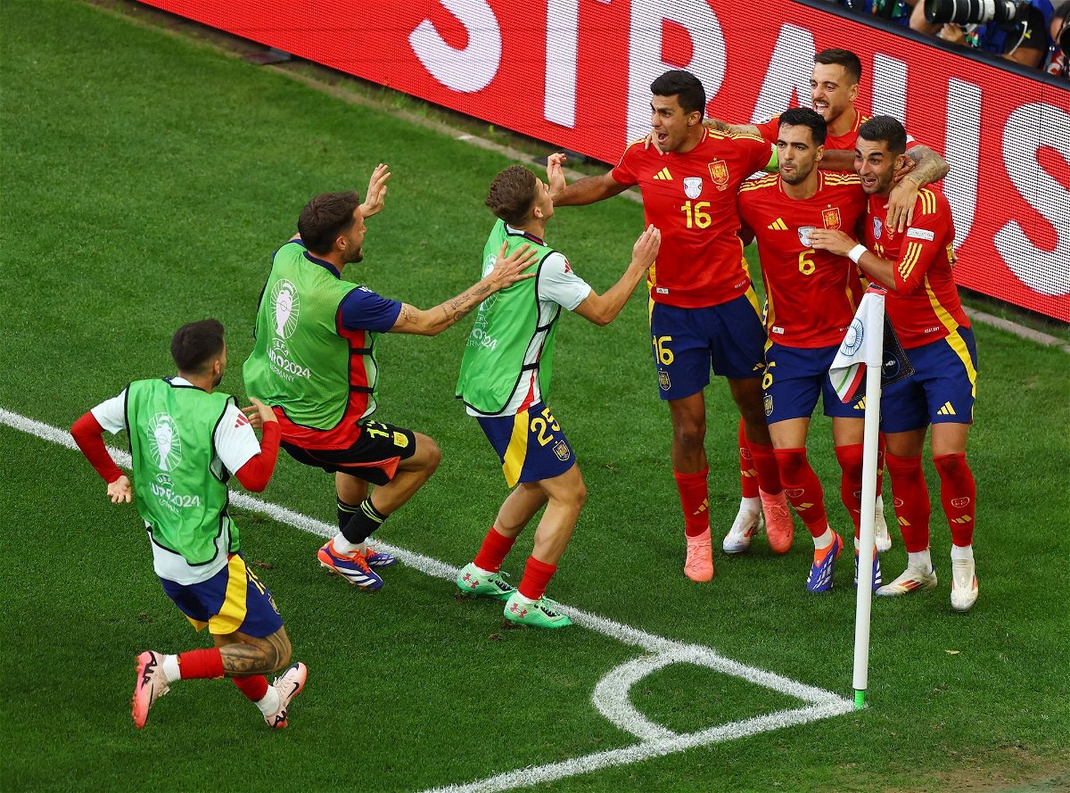 <i>Leonhard Simon/Reuters via CNN Newsource</i><br/>Spain's Mikel Merino celebrates with teammates after scoring the quarterfinal winner against Germany.