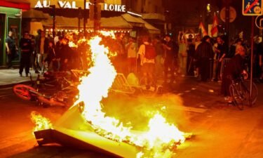 A barricade burns as protesters demonstrate against the far right in Paris