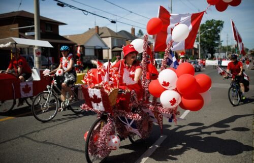 A cyclist rides in the East York Canada Day Parade in July 2019 in Toronto