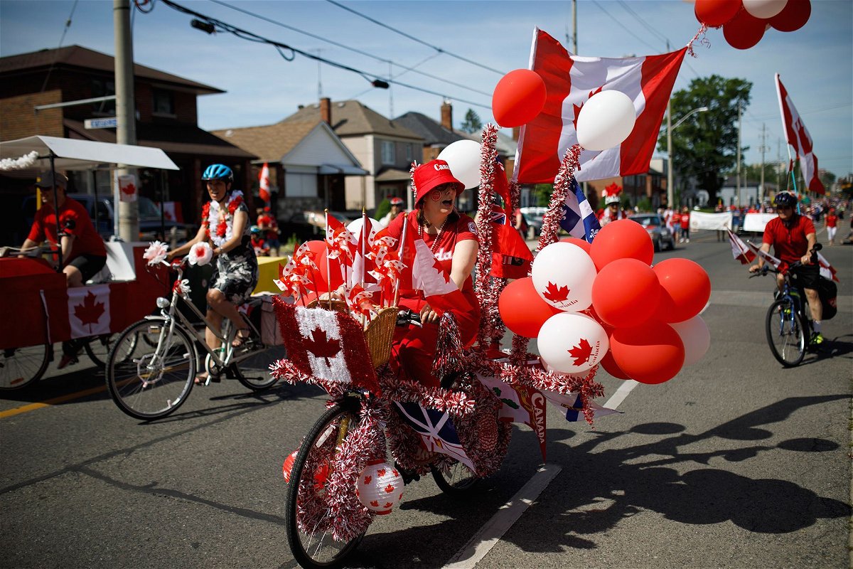 <i>Cole Burston/Getty Images via CNN Newsource</i><br/>A cyclist rides in the East York Canada Day Parade in July 2019 in Toronto