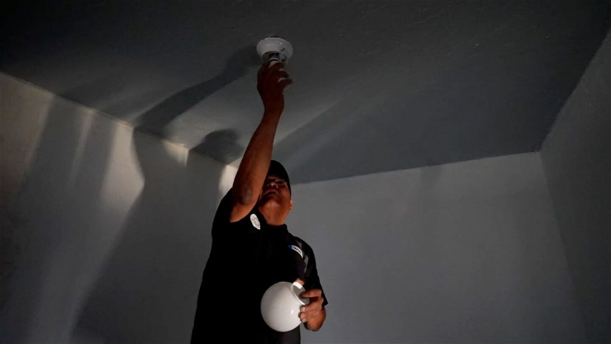 <i>Joel De La Rosa/CNN via CNN Newsource</i><br/>William Lee Tom Jr. screws in a lightbulb at his Navajo Nation home.