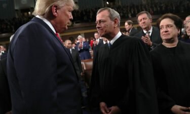 President Donald Trump talks with Supreme Court Chief Justice John Roberts as Associate Justice Elena Kagan looks on before the State of the Union address in the House chamber on February 4