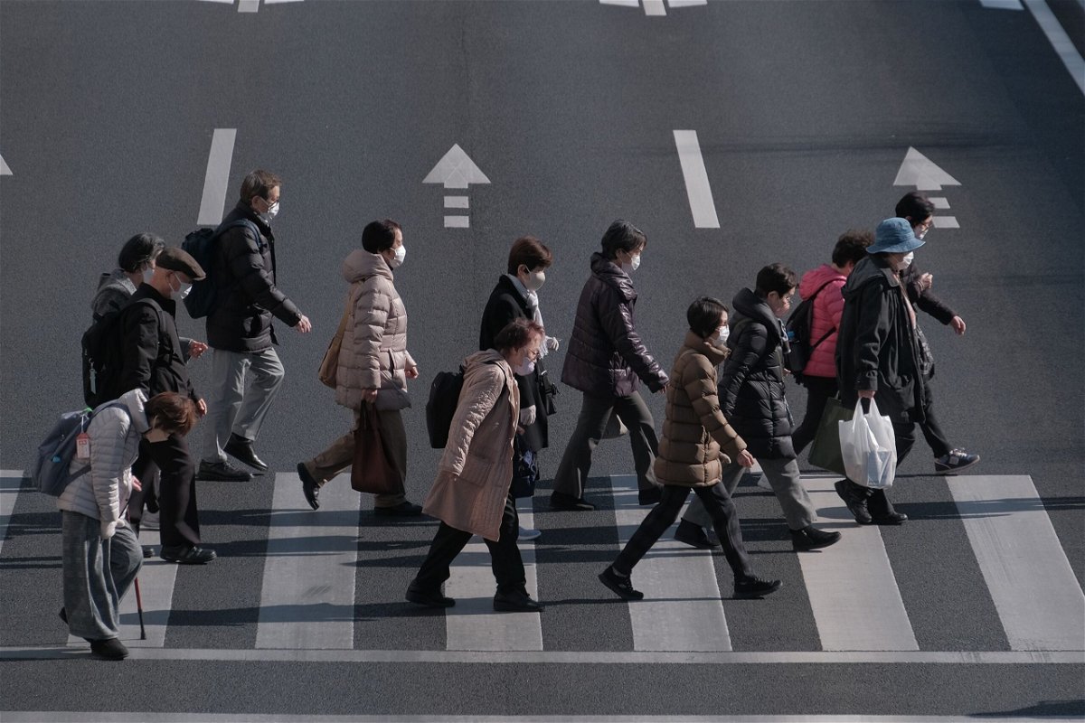 <i>Soichiro Koriyama/Bloomberg/Getty Images via CNN Newsource</i><br/>Pedestrians cross an intersection in the Itabashi district of Tokyo