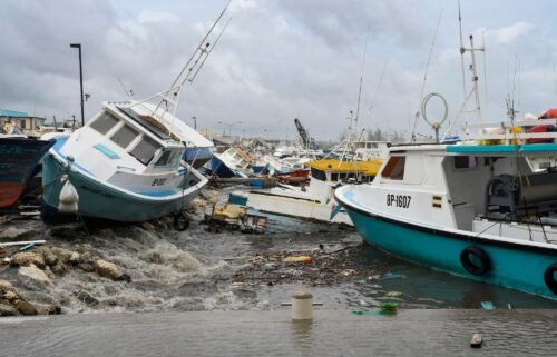 Damaged fishing boats rest on the shore after the passing of Hurricane Beryl at the Bridgetown Fish Market