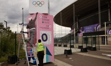 Workers prepare an information board outside Stade de France in Saint Denis on July 3. The Paris 2024 Olympic Games will run from July 26 to August 11.