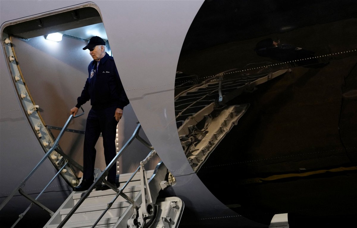 <i>Kent Nishimura/AFP/Getty Images via CNN Newsource</i><br/>President Joe Biden gestures to reporters as he steps off Air Force One upon arrival at Dover Air Force Base in Dover