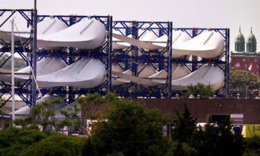 Giant wind turbine blades for the Vineyard Winds project are stacked on racks in New Bedford