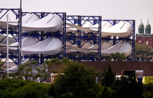 Giant wind turbine blades for the Vineyard Winds project are stacked on racks in New Bedford