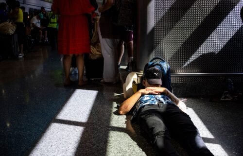 A passenger takes a nap inside a terminal at Harry Reid International Airport on July 19