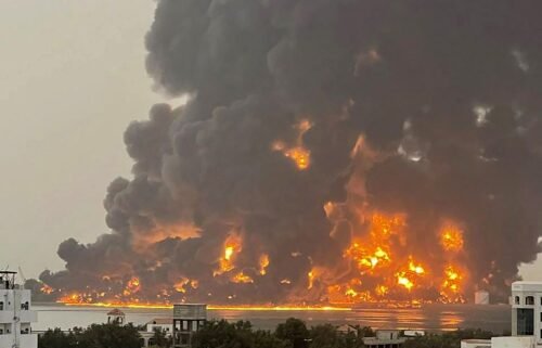 A handout picture obtained from Yemen's Houthi Ansarullah Media Center shows a huge column of fire erupting following reported strikes in the Yemeni rebel-held port city of Hodeida on July 20.