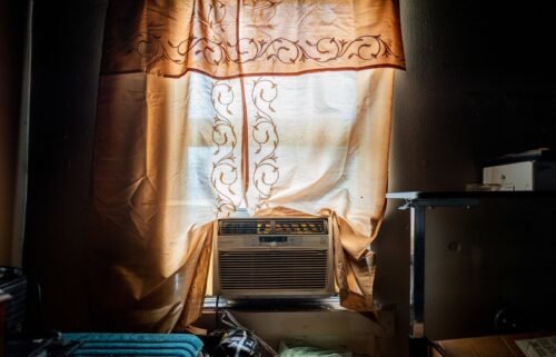 Larry Nelson's unpowered AC unit sits in the window sill of his home in the Third Ward neighborhood on July 12 in Houston