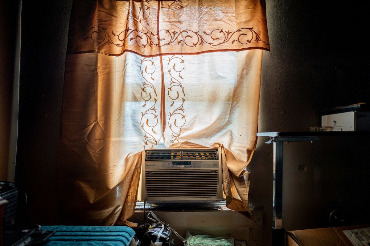 <i>Brandon Bell/Getty Images via CNN Newsource</i><br/>Larry Nelson's unpowered AC unit sits in the window sill of his home in the Third Ward neighborhood on July 12 in Houston
