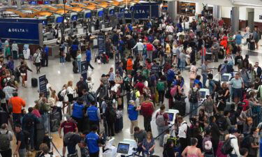 People wait in line at Hartsfield-Jackson International Airport on July 20 in Atlanta