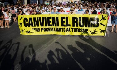 Protesters hold a banner which reads as "Let's change course" during a demonstration against mass tourism and housing prices held in Palma de Mallorca on the Spanish island of Mallorca.