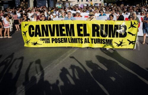 Protesters hold a banner which reads as "Let's change course" during a demonstration against mass tourism and housing prices held in Palma de Mallorca on the Spanish island of Mallorca.