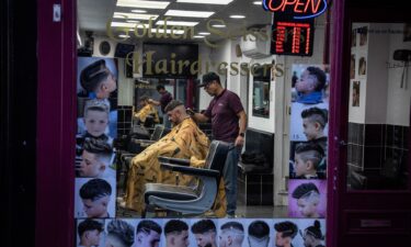 A man gets his hair cut in a barber shop in Colchester