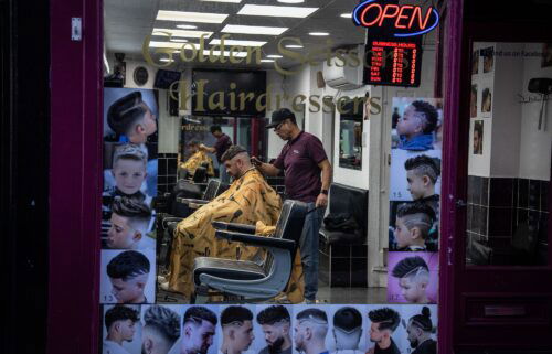 A man gets his hair cut in a barber shop in Colchester