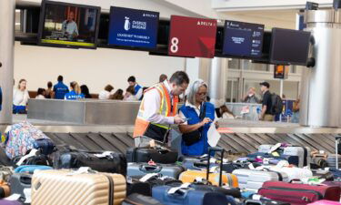 Delta Air Lines employees try to locate passengers' luggage after cancelled and delayed flights at Hartsfield-Jackson Atlanta International Airport on July 22.