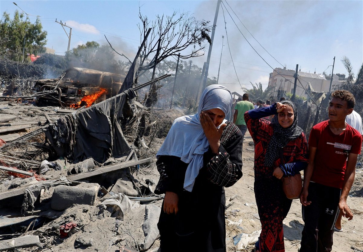 <i>Mohammed Salem/Reuters via CNN Newsource</i><br/>Palestinians react near damages