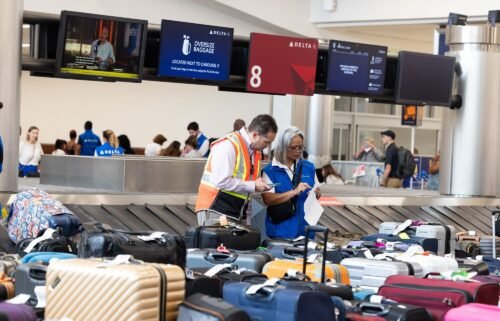 Delta employees try to locate passengers' luggage at Hartsfield-Jackson Atlanta International Airport on July 23.