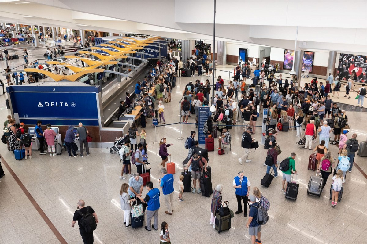 <i>Jessica McGowan/Getty Images via CNN Newsource</i><br/>Delta Air Lines passengers line up for agent assistance at Hartsfield International Airport in Atlanta on July 22.