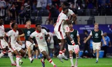 Canada midfielder Ismaël Koné celebrates with his teammates after making the winning penalty kick.