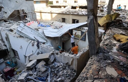 Palestinians asses the damage following an Israeli strike in the Nuseirat refugee camp in the central Gaza Strip on July 6