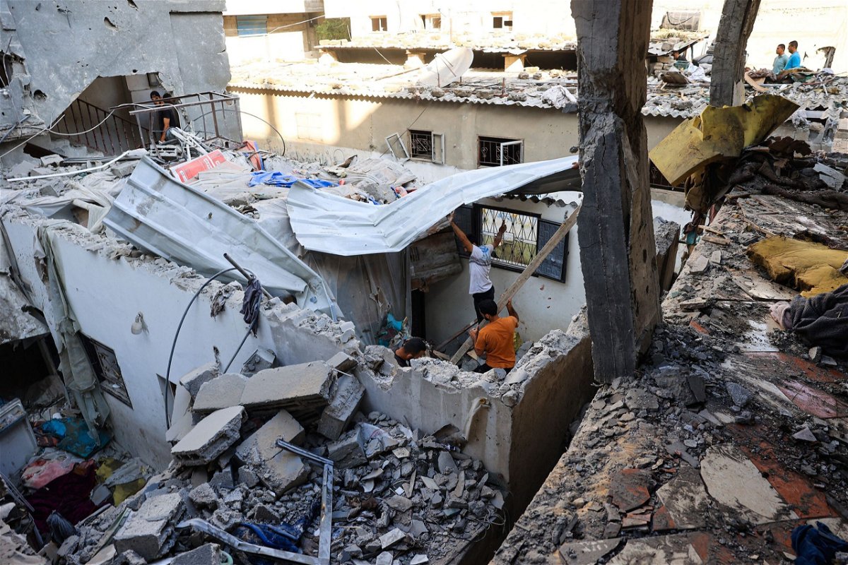 <i>Eyad Baba/AFP/Getty Images via CNN Newsource</i><br/>Palestinians asses the damage following an Israeli strike in the Nuseirat refugee camp in the central Gaza Strip on July 6