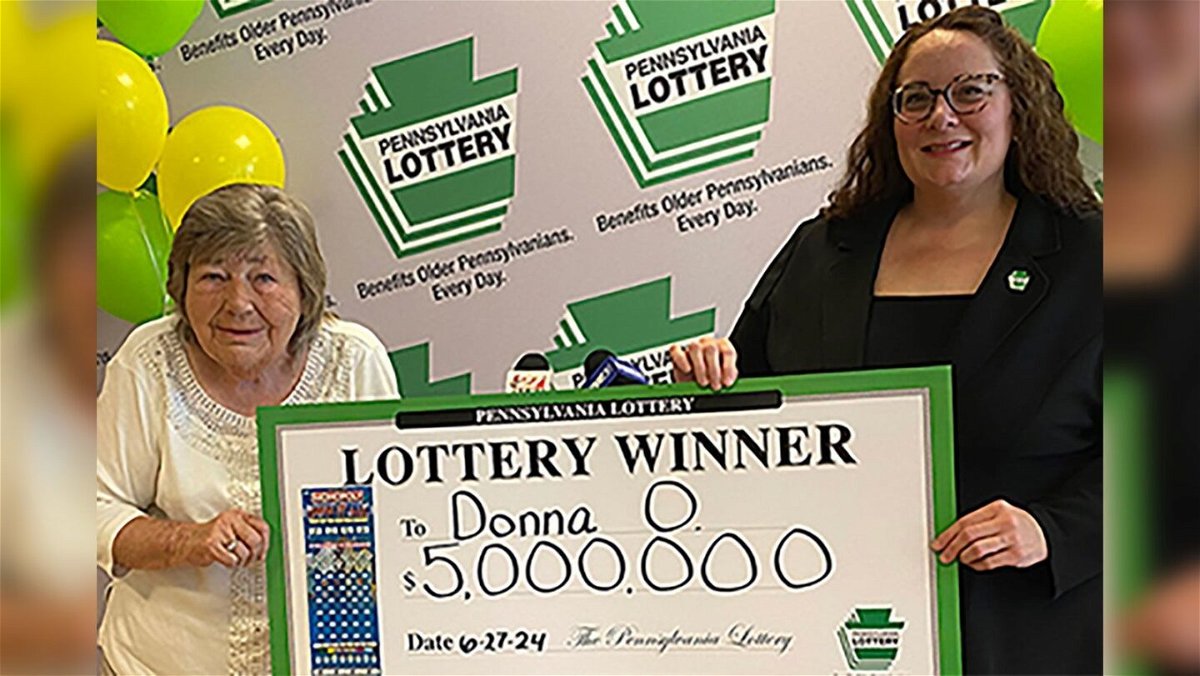 <i>Pennsylvania Lottery via CNN Newsource</i><br/>Winner Donna Osborne holds her check with Pennsylvania Lottery Deputy Director of Corporate Sales Staci Coombs.