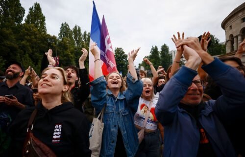 Supporters of the far-left France Unbowed party celebrate the second round results in Paris