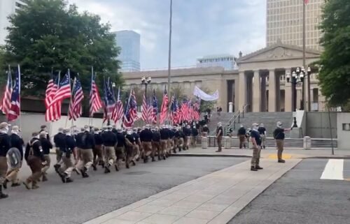 Protesters believed to be affiliated with the White supremacist group Patriot Front march near the Tennessee House of Representatives and the Tennessee State Capitol.