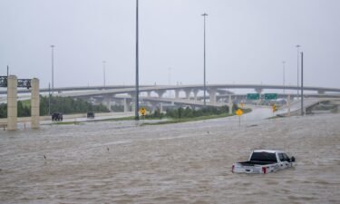 A vehicle is left abandoned in floodwater on a highway after Hurricane Beryl swept through the area on July 8 in Houston