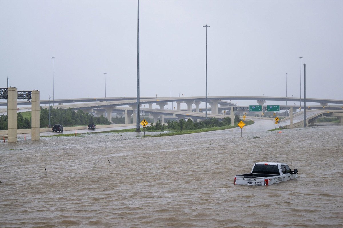 <i>Brandon Bell/Getty Images via CNN Newsource</i><br/>A vehicle is left abandoned in floodwater on a highway after Hurricane Beryl swept through the area on July 8 in Houston