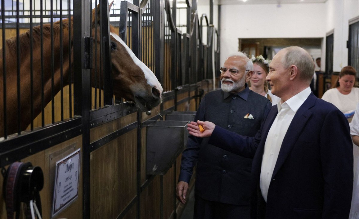 <i>Gavrill Grigorov/Pool/AFP/Getty Images via CNN Newsource</i><br/>Russian President Vladimir Putin and Indian Prime Minister Narendra Modi visit a stable during an informal meeting outside Moscow