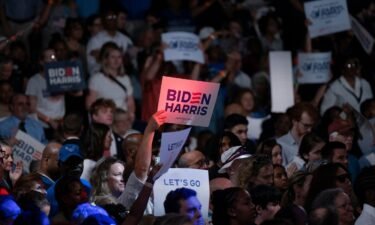 People wave signs at a post-debate campaign rally for U.S. President Joe Biden on June 28