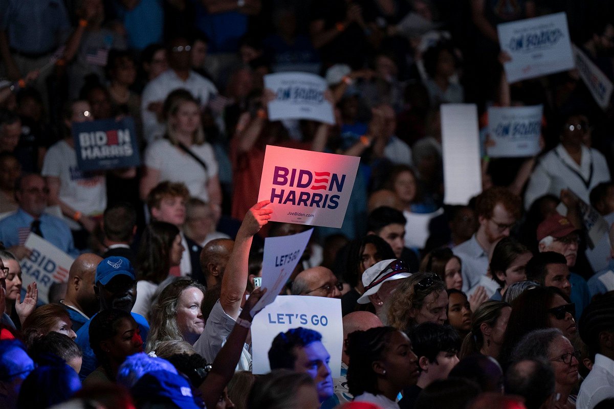 <i>Allison Joyce/Getty Images via CNN Newsource</i><br/>People wave signs at a post-debate campaign rally for U.S. President Joe Biden on June 28