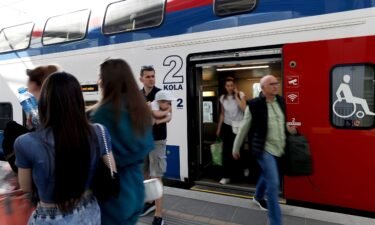 Passengers get off the train at Novi Sad railway station in Novi Sad