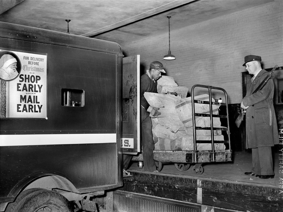 <i>Universal History Archive/Universal Images Group/Getty Images via CNN Newsource</i><br/>Workers on loading platform putting mail on trucks in 1938.
