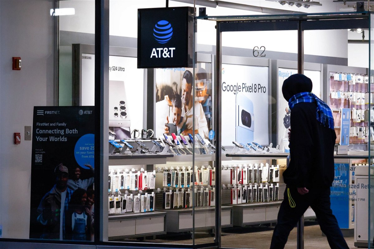 <i>Kena Betancur/VIEWpress/Corbis/Getty Images via CNN Newsource</i><br/>A person walks past an AT&T Store in Midtown Manhattan on January 23