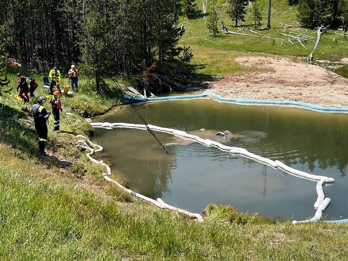 <i>National Park Service via CNN Newsource</i><br/>Crews work Friday to lift a car out of the Semi-Centennial Geyser at Yellowstone National Park.