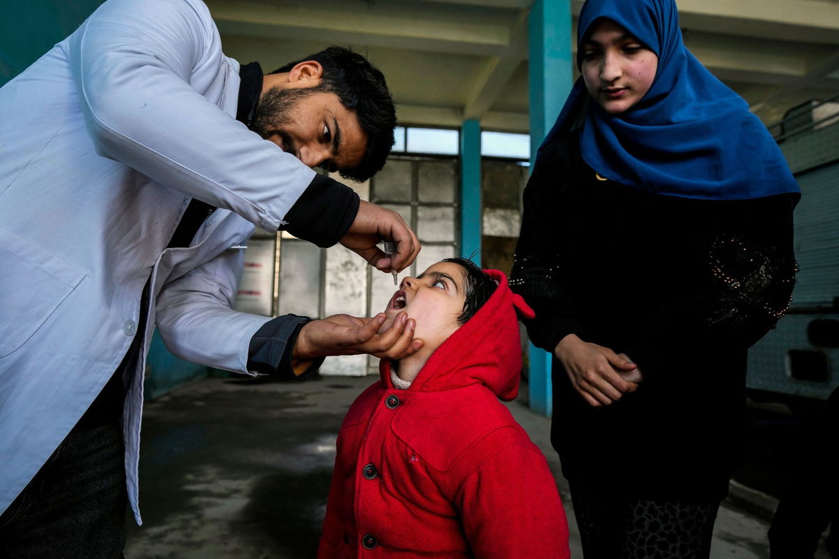 <i>Mukhtar Khan/AP via CNN Newsource</i><br/>A government health worker administers polio drops to a child in Srinagar