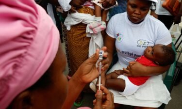 A health employee prepares to give a malaria injection to a child during the official ceremony for the launch of a malaria vaccination campaign in Ivory Coast.