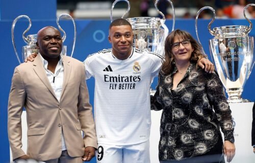 Kylian Mbappe poses with his parents inside the Santiago Bernabéu.