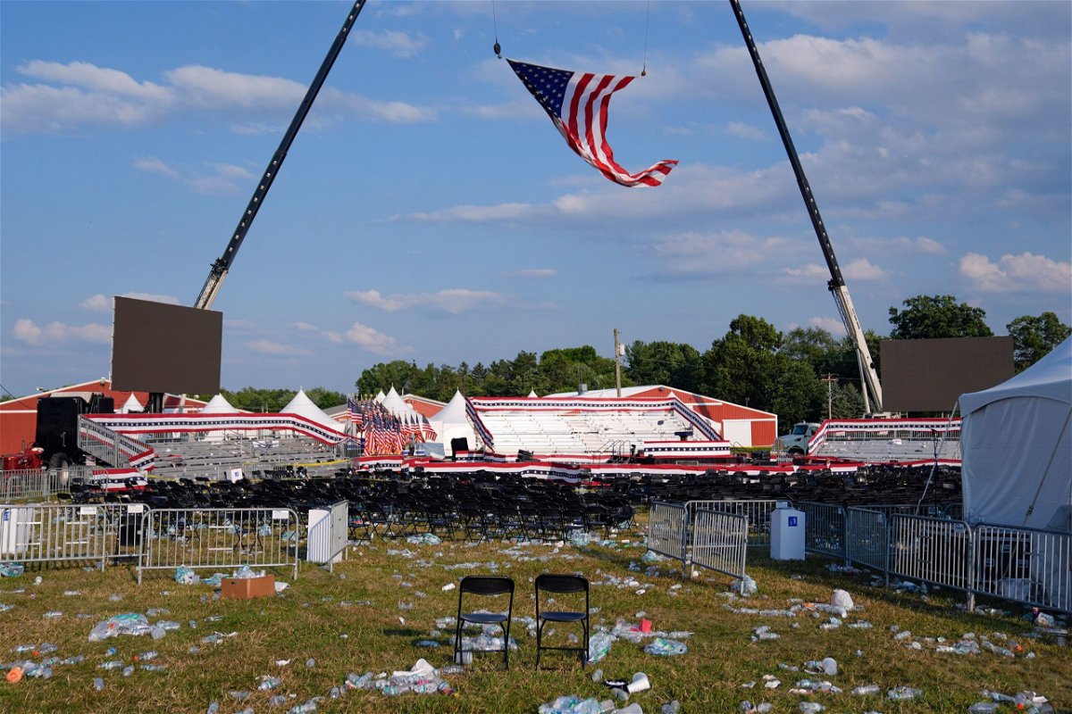 <i>Evan Vucci/AP via CNN Newsource</i><br/>A campaign rally site for former President Donald Trump is empty and littered with debris Saturday