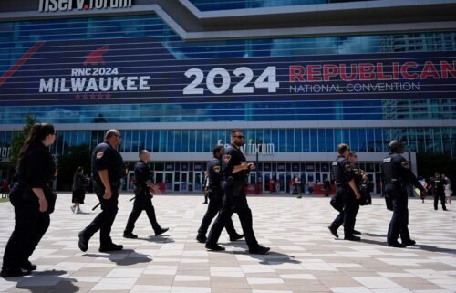 Law enforcement officers walk around the Fiserv Forum before the Republican National Convention