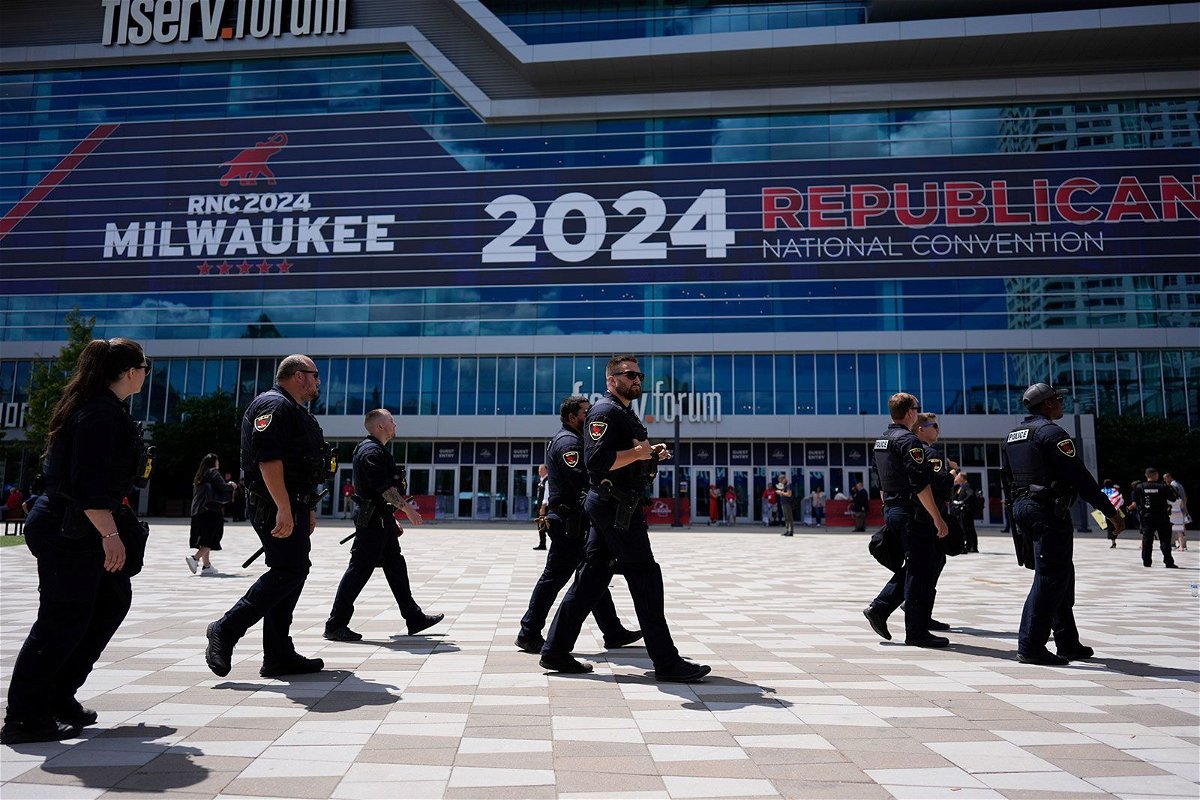 <i>Jae C. Hong/AP via CNN Newsource</i><br/>Law enforcement officers walk around the Fiserv Forum before the Republican National Convention