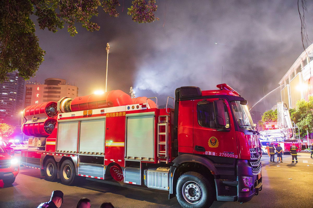 <i>Visual China Group/Getty Images via CNN Newsource</i><br/>Fire officers work at the site of a department store blaze on July 17