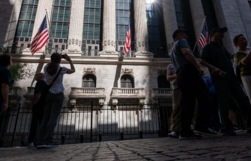 People walk through the Financial District near the New York Stock Exchange on July 11