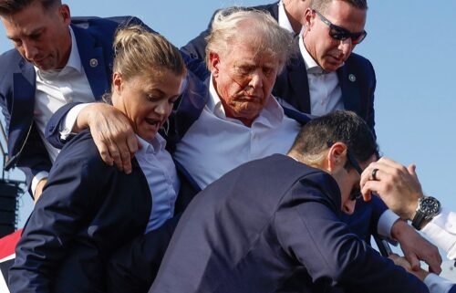 Former President Donald Trump is rushed offstage by U.S. Secret Service agents after being grazed by a bullet during a rally on July 13